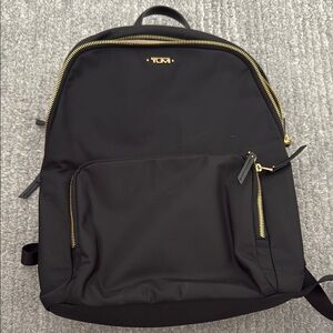 TUMI Black Backpack with Gold Accents
